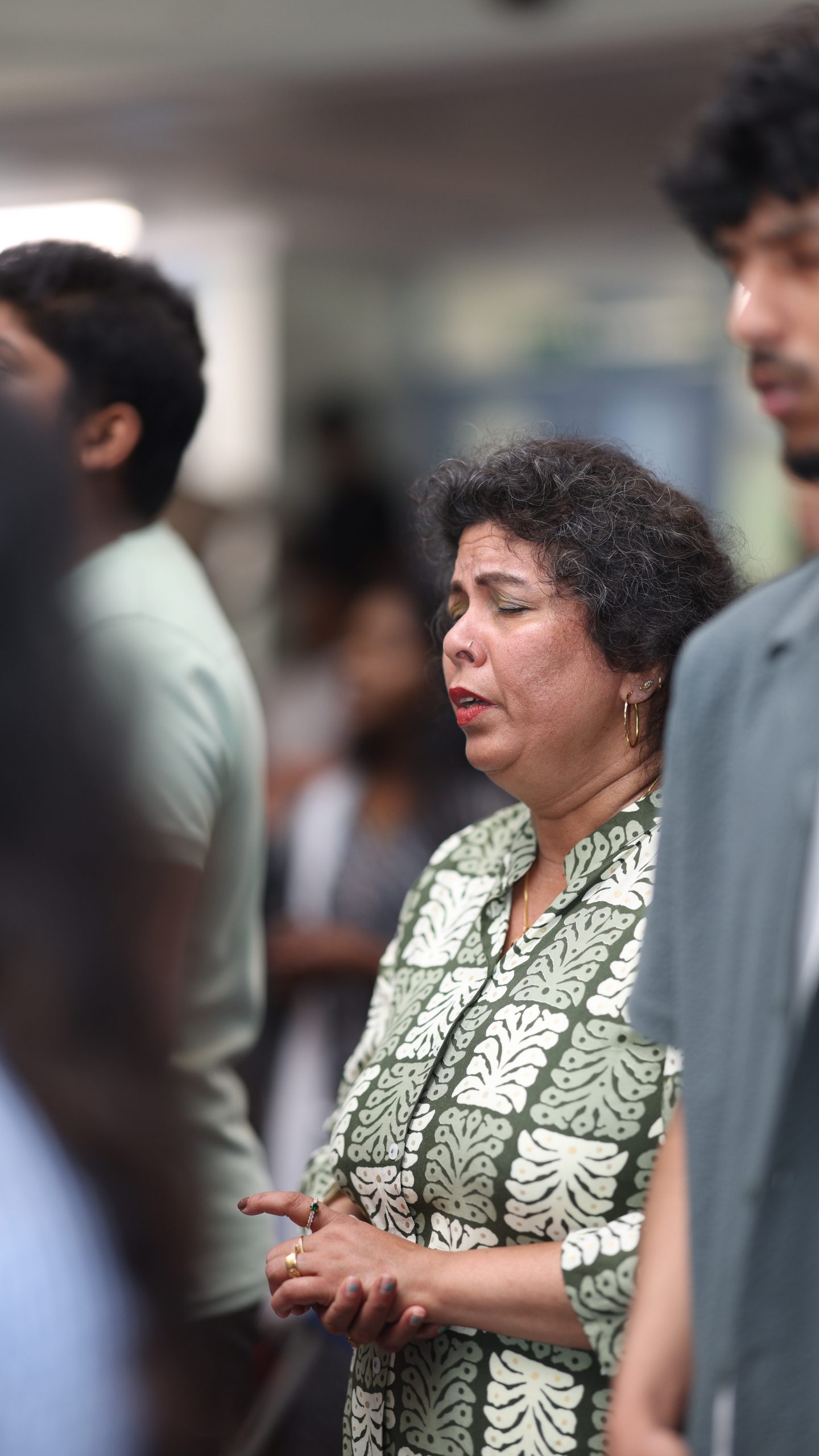 A woman praying with her eyes closed during the service
