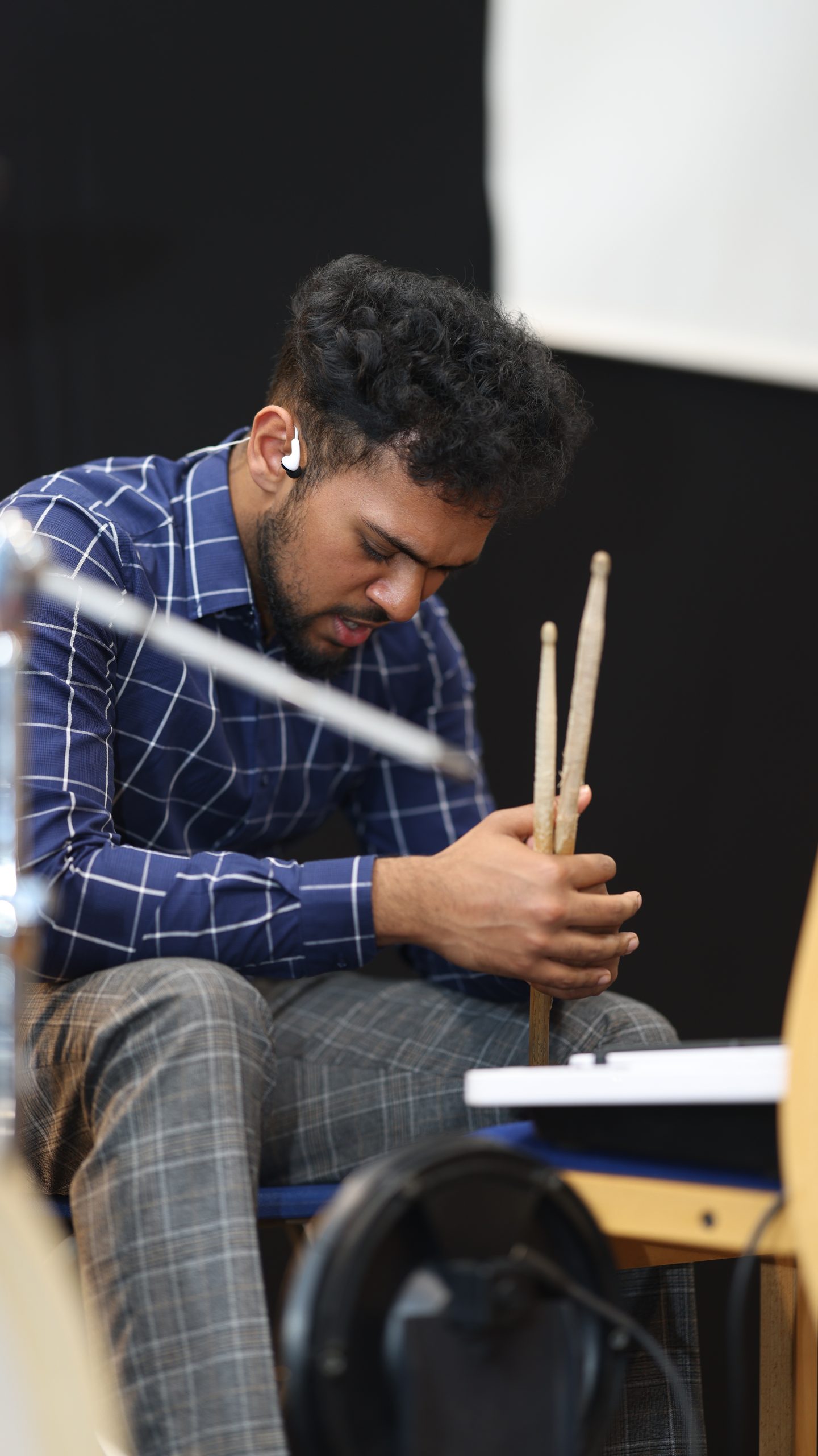 Drummer holding his sticks with his head bowed