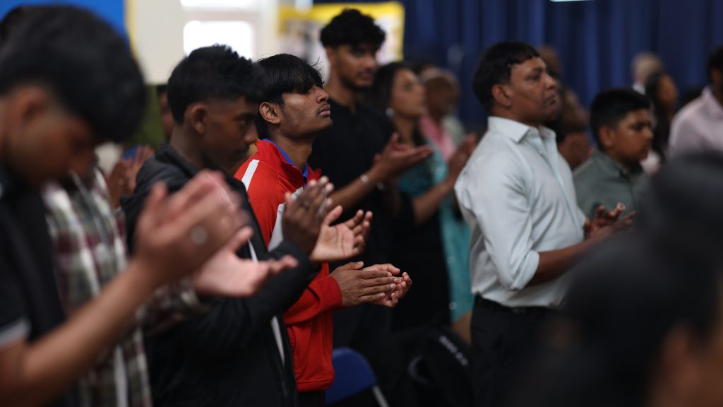 Young people clapping during worship