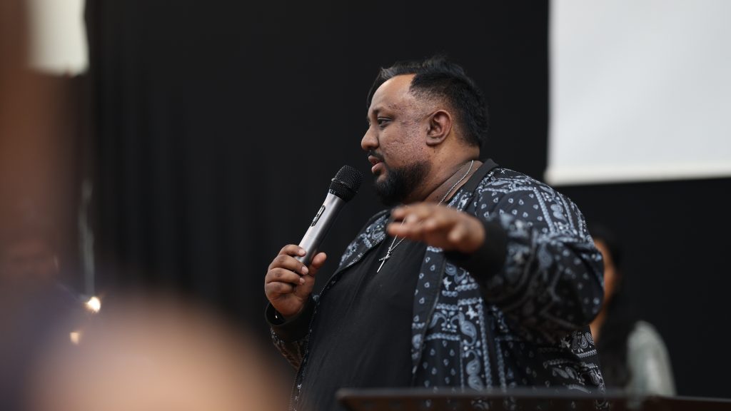 Preacher speaking into a microphone during the service