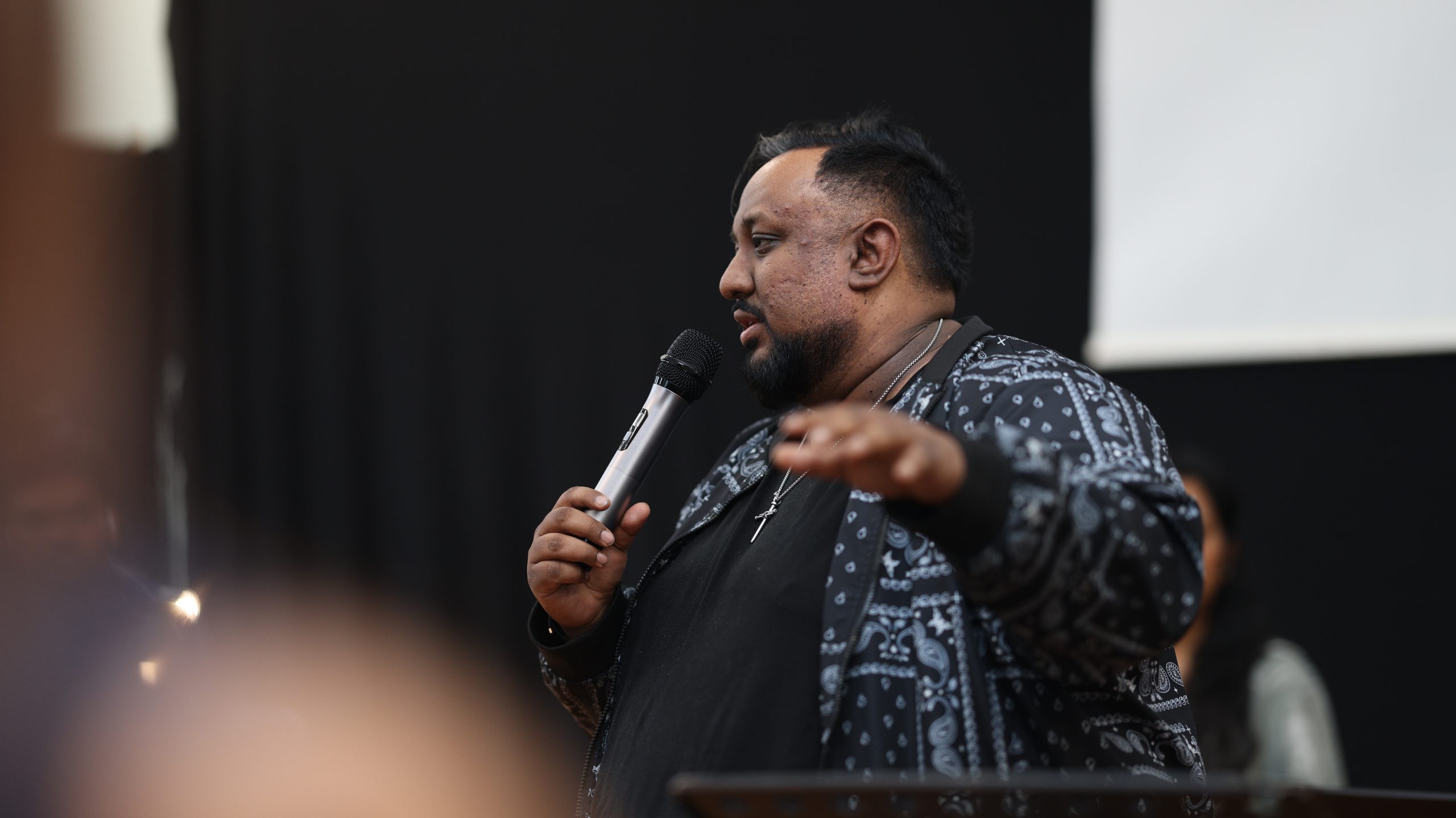 Preacher speaking into a microphone during the service